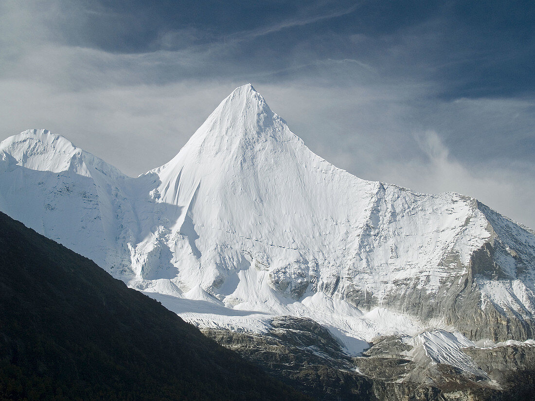 storm clouds begin to gather on Yanmaiyang, Yading National Park, Szechuan, China