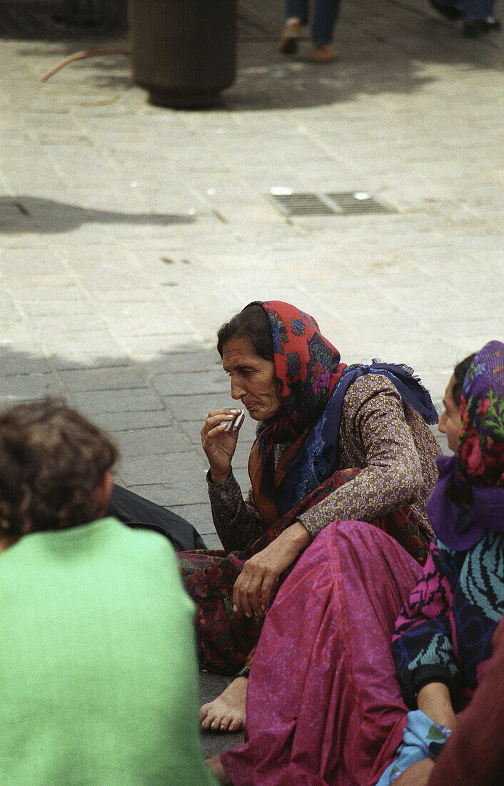 Gypsie smoking outside Forum Les Halles in Paris, France.