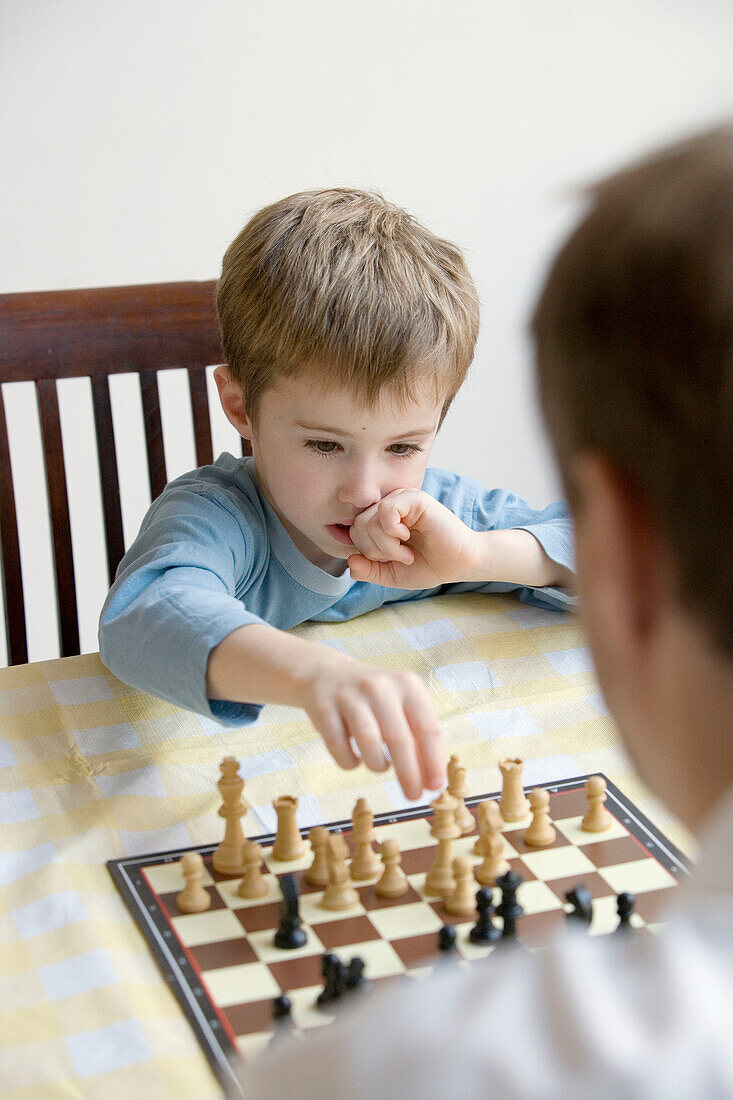 30-40 years, 5 to 10 years, 5-10 years, 6-7 years, Boy, Caretaker, Caucasian, Chess, Chessboard, Child, Color, Colour, Contemporary, Educate, Education, Father, Game, Home, Indoor, Indoors, Inside, Interior, Kid, Learn, Learning, Parent, Play, Playing, Sk
