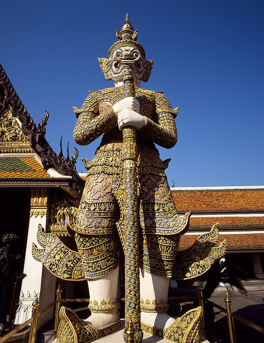 Statue in front of Temple of the Emerald Buddha (Wat Phra Keo). Bangkok, Thailand