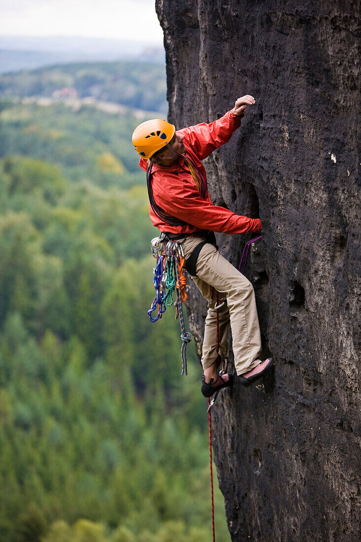 A young man climbing on rock, Grosse Hunskirche, Papststein, Elbe Sandstone Mountains, Saxon Switzerland, Saxony, Germany
