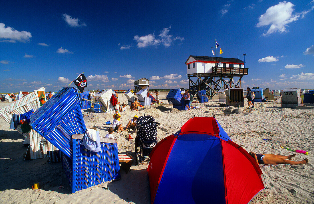 Beach chairs and stilted house under blue sky, St. Peter Ording, Eiderstedt peninsula, Schleswig Holstein, Germany, Europe