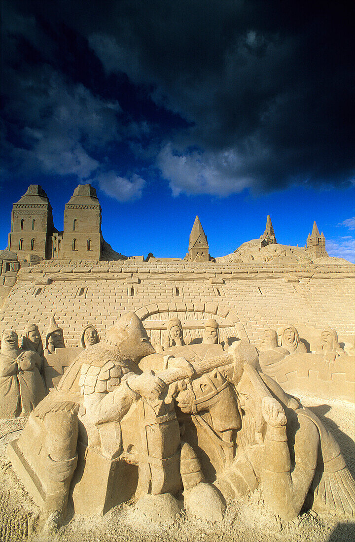 Artful sand sculptures under dark clouds, Travemünde, Schleswig Holstein, Germany, Europe