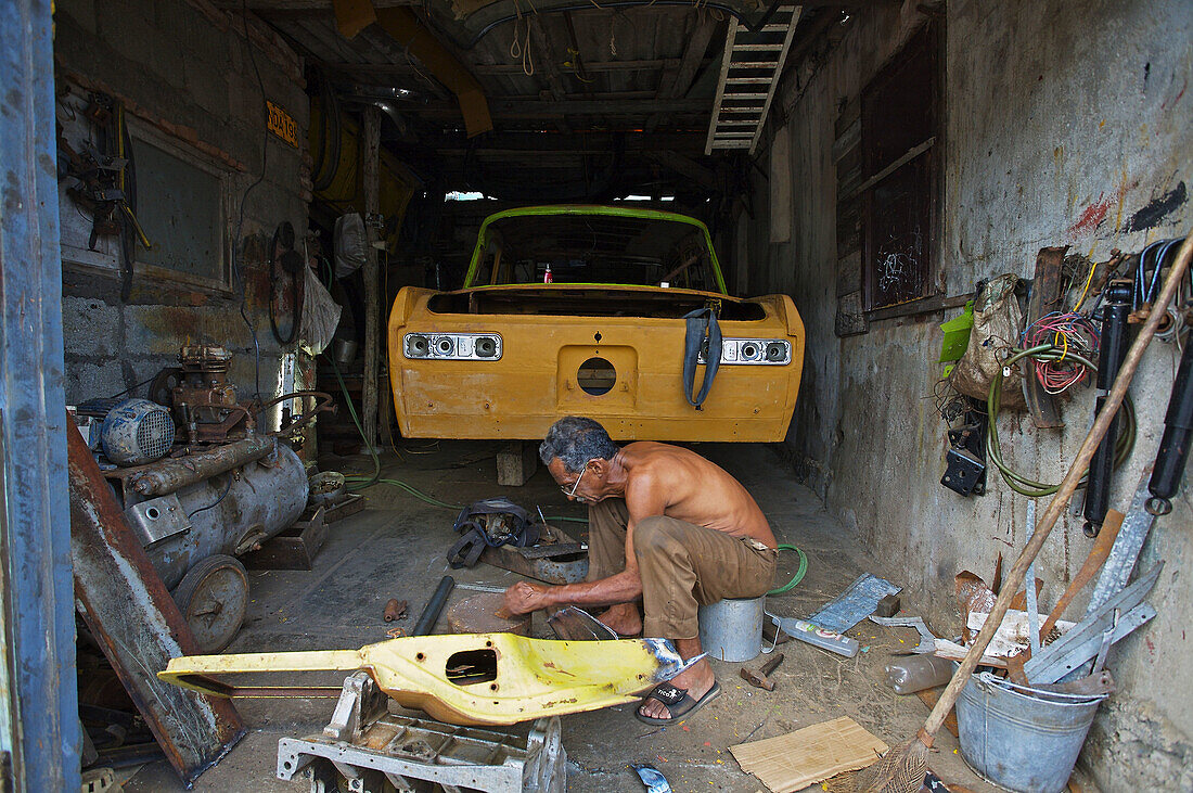 Man building his own car, Baracoa. Guantánamo province. Cuba.