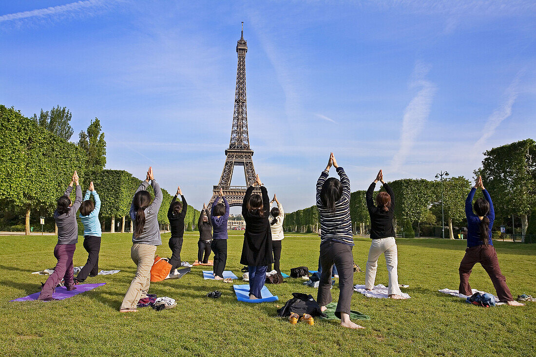 People doing Yoga, Eiffel Tower. Paris. France