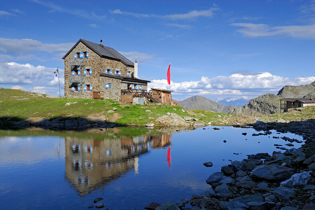 hut Flaggerschartenhütte with reflections in a lake, Marburg-Siegener Hütte, Rifugio Forcella di Vallaga, Sarntal range, South Tyrol, Alta Badia, Italy