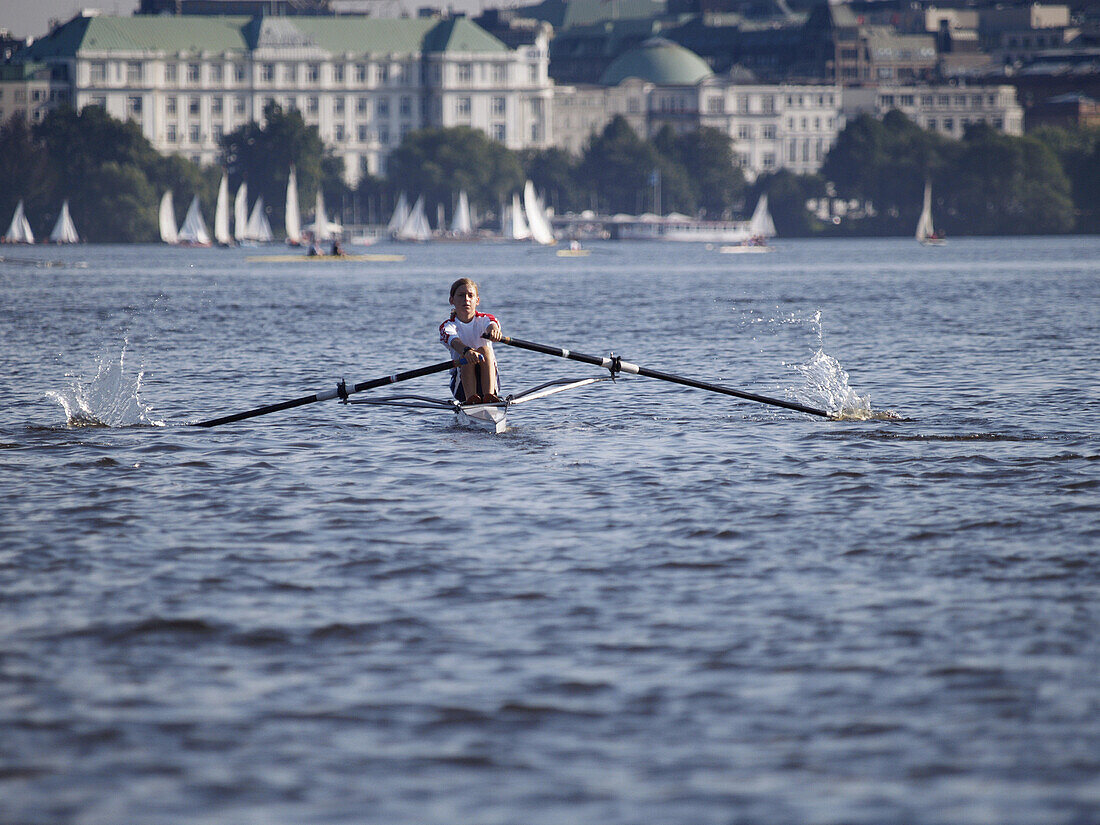 Boy rowing on the Lake Alster, Hamburg, Germany