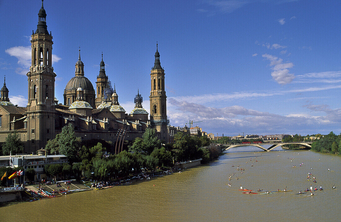 Canoe competition. Nuestra Señora del Pilar festival. El Pilar basilica and Ebro river. Zaragoza. Aragon, Spain.