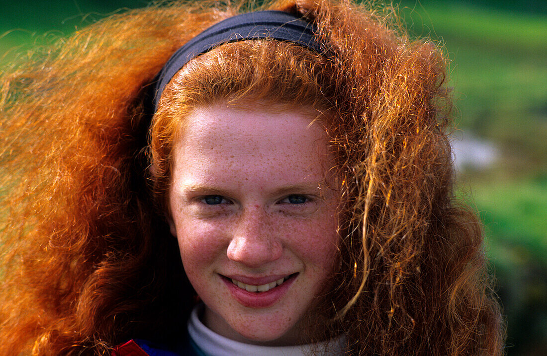 Redheaded smiling girl, Ballintoy, County Antrim, Ireland, Europe