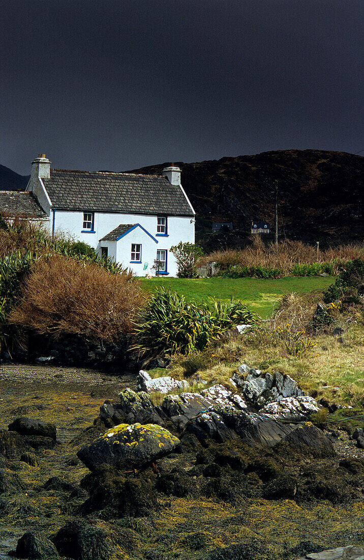 Cottage at Coulagh Bay under rain clouds, County Kerry, Ireland, Europe