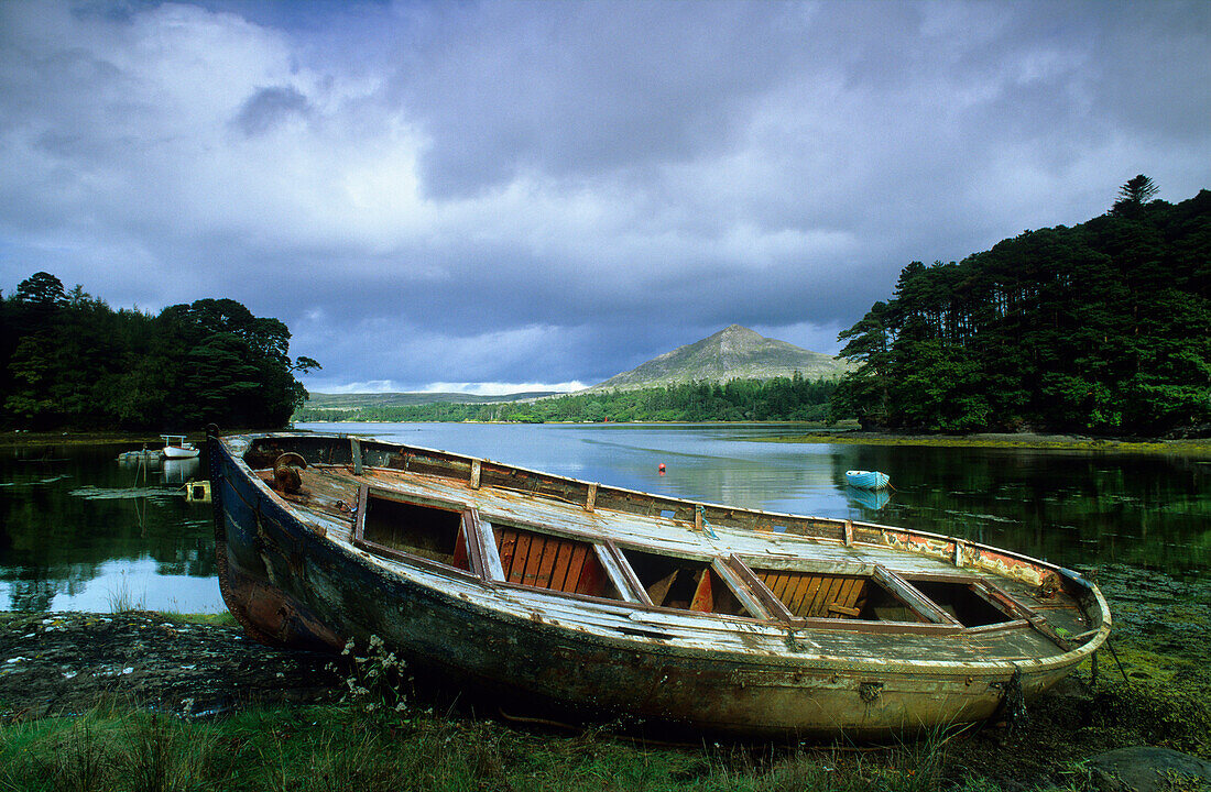 Small boat on shore of a lake at the Ring of Beara, County Kerry, Ireland, Europe