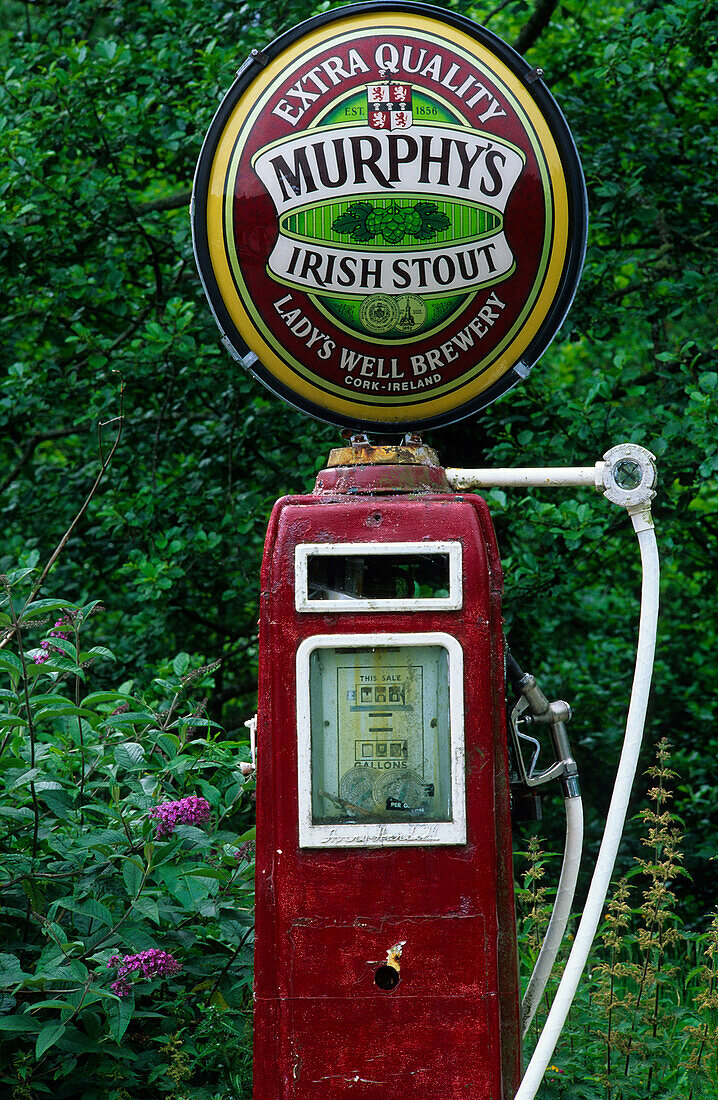 Old gas station, petrol station with Murphys beer sign on top near a pub in Lauragh on the Ring of Beara, County Kerry, Ireland, Europe