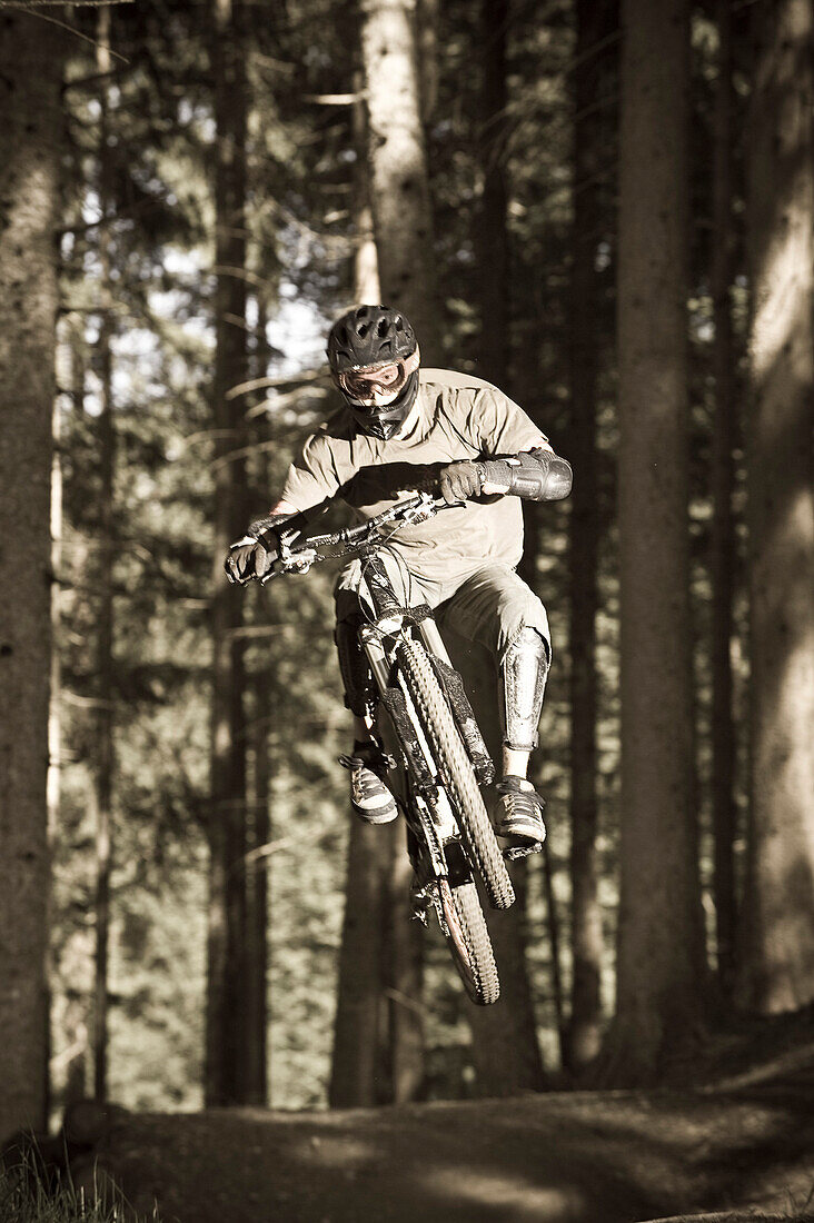 A teenager on his mountain bike during a jump, Downhill Park, Wagrain, Austria