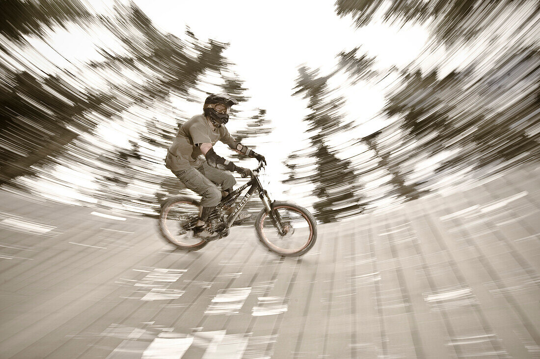A teenager driving a ground loop with his mountain bike, Downhill Park, Wagrain, Austria