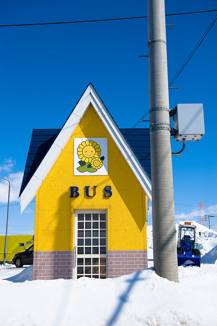Bus shelter at the bus stop in the snow under blue sky, Hokkaido, Japan, Asia