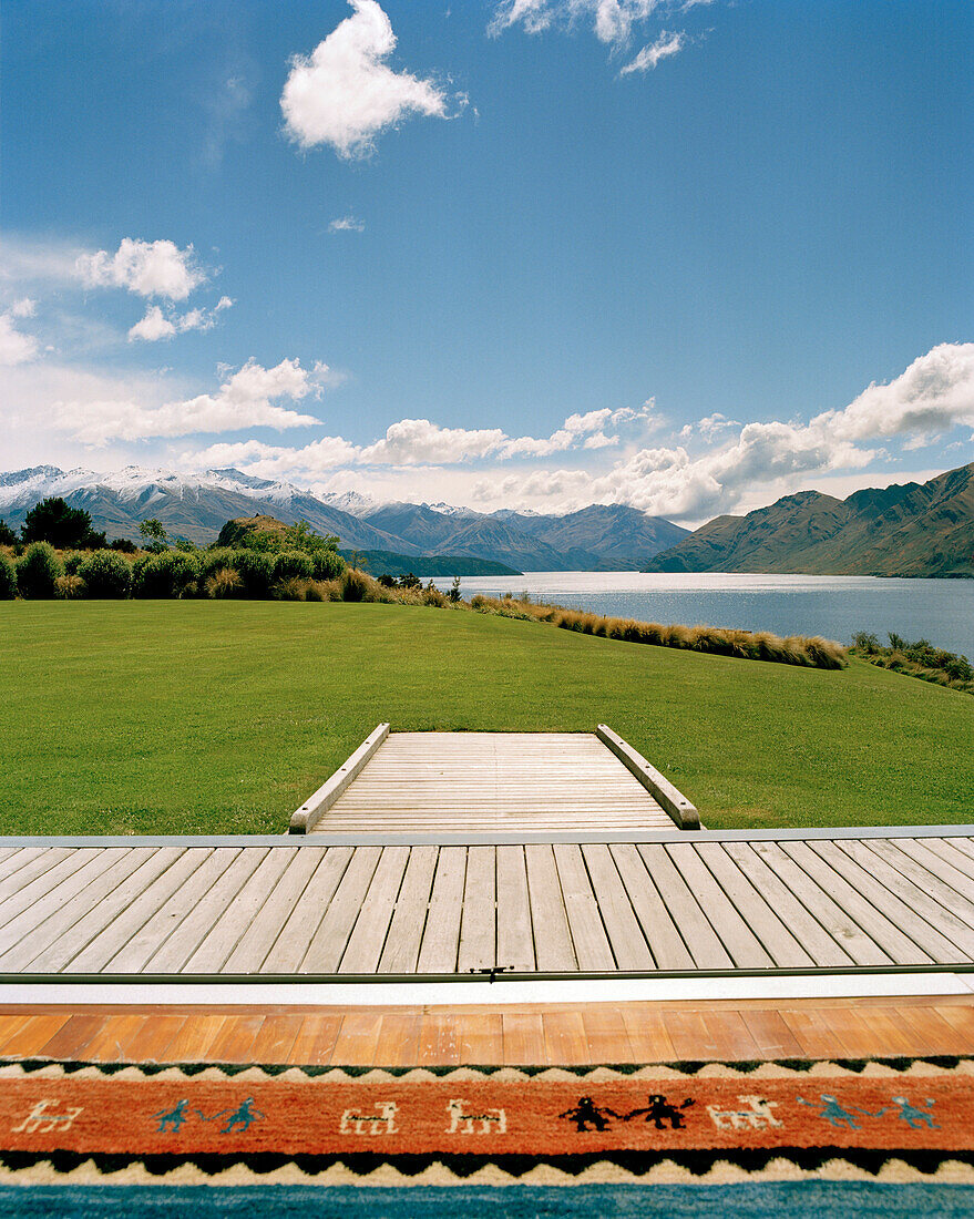 Terrace and garden of luxury Whare Kea Lodge in the sunlight, Lake Wanaka, Wanaka, Central Otago, South Island, New Zealand