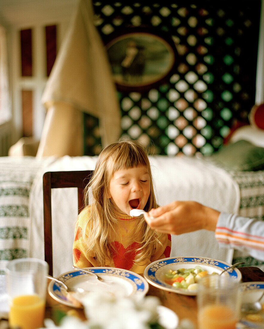 Girl having breakfast on the balcony, Rowendale Homestead, Okains Bay, Banks Peninsula, South Island, New Zealand