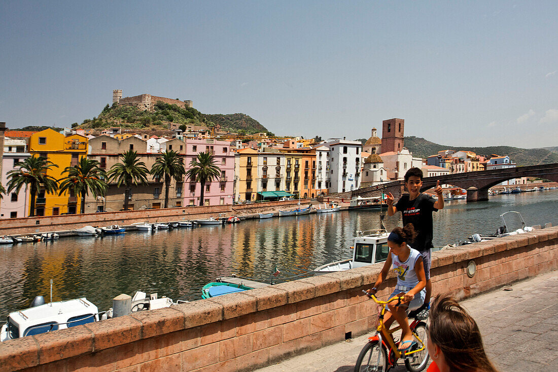 Italy Sardinia Bosa west coast canal, children on bicycle