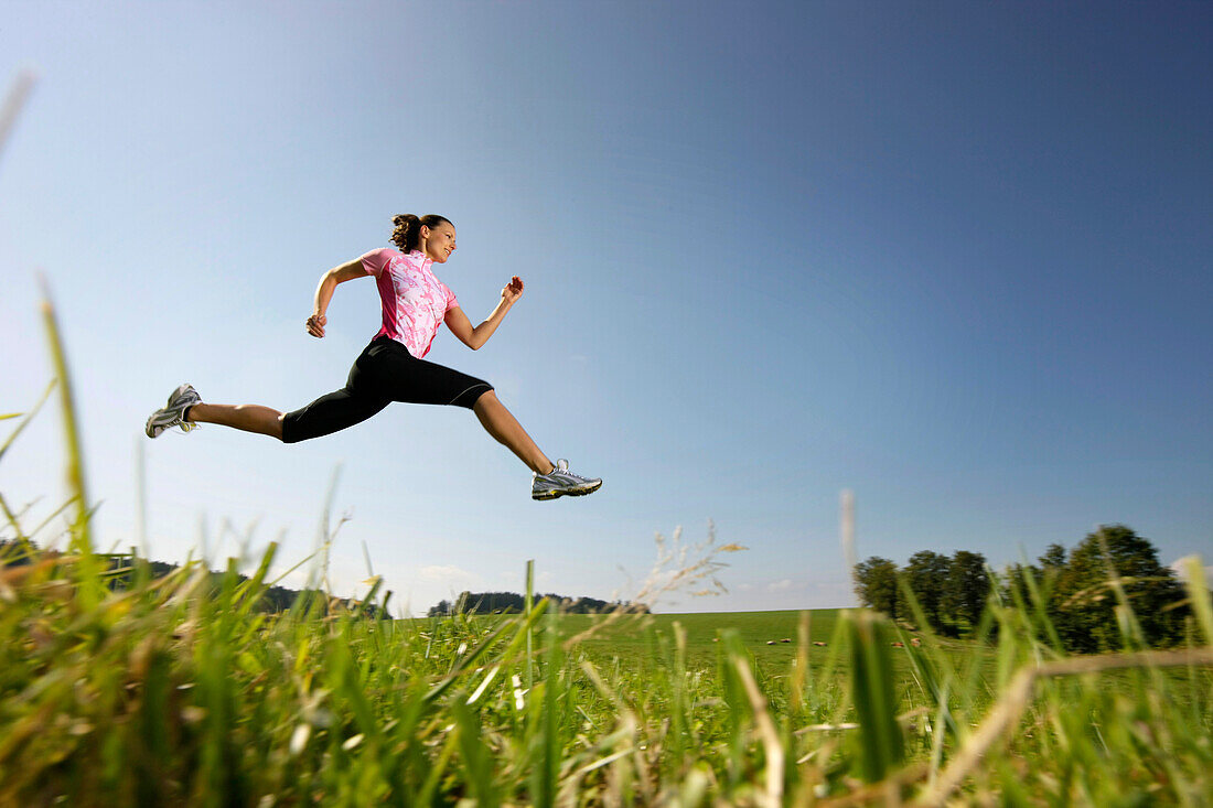 Woman jumping on meadow