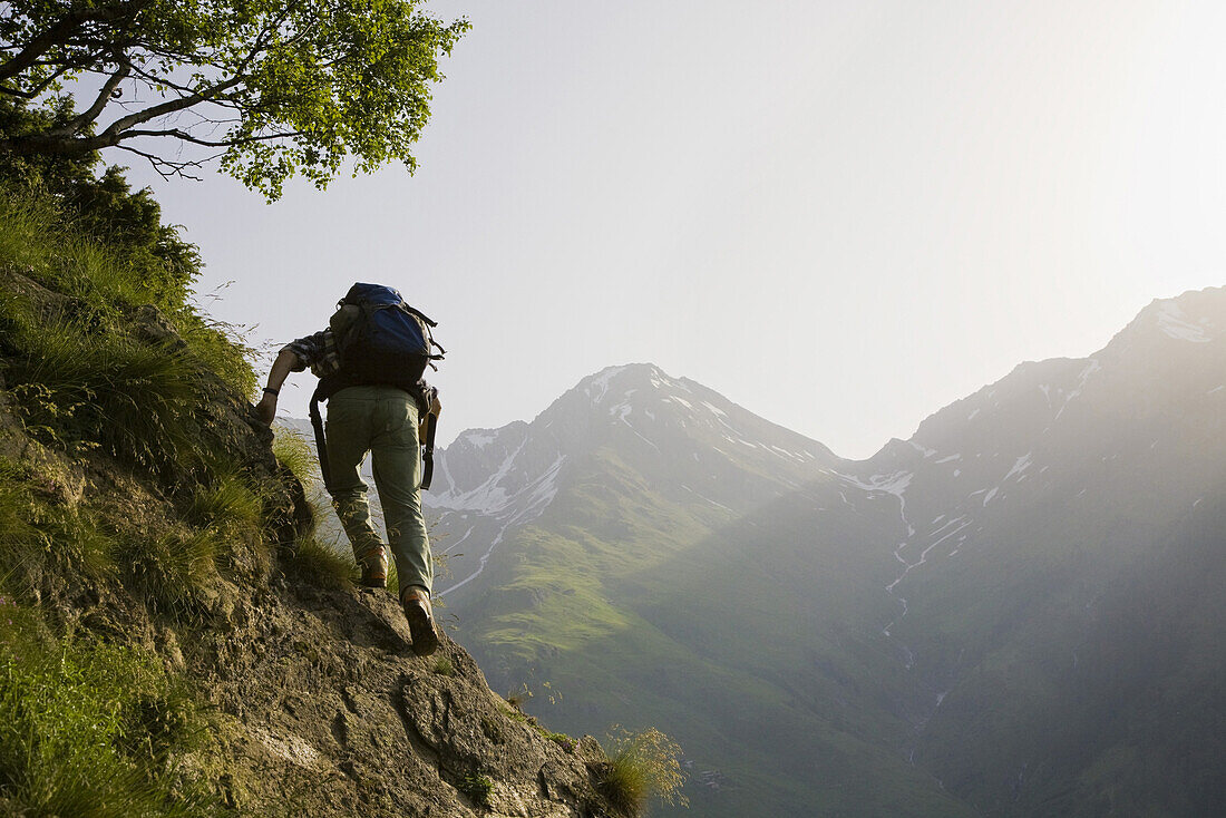 Hiker on narrow trail, Baldschieder Valley, Bernese Alps, Canton of Valais, Switzerland