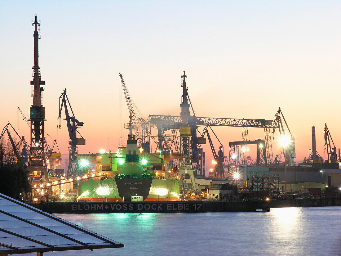 Illuminated shipyard at the harbour in the evening, Hanseatic City of Hamburg, Germany