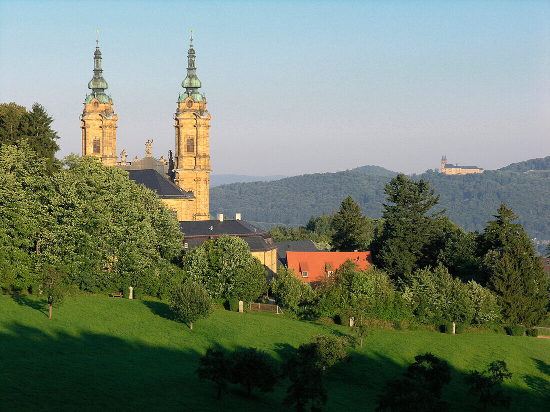 Basilica ot the Fourteen Holy Helpers behind treetops in the sunlight, Franconia, Bavaria, Germany