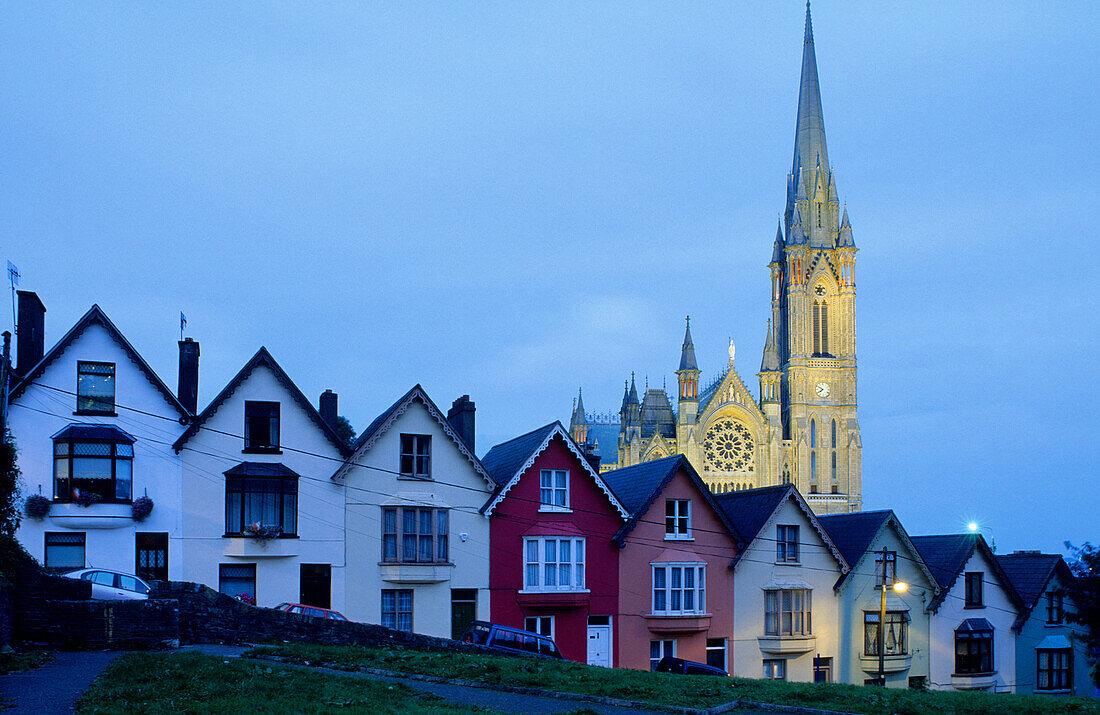 Europe, Great Britain, Ireland, Co. Cork, painted houses in the town centre of Cobh (West View), in the background St. Coleman's cathedral
