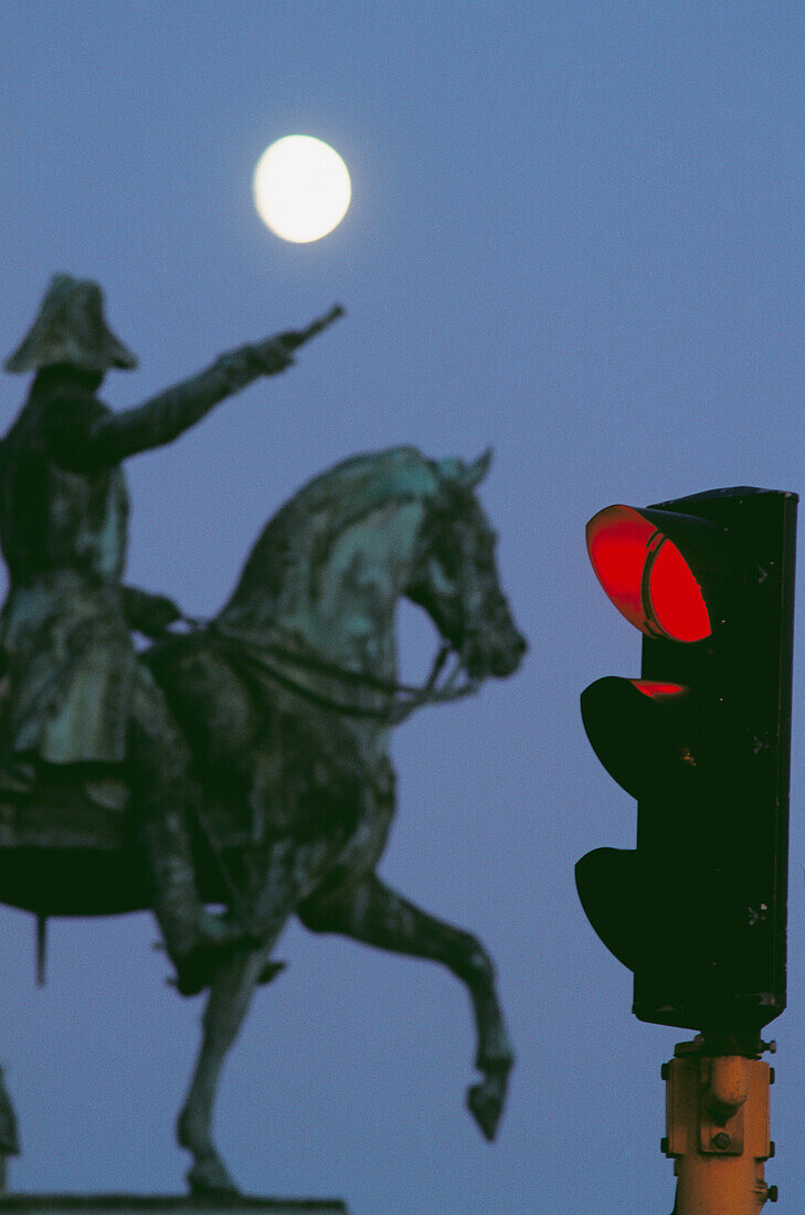 Statue and traffic light at night in old town, Stockholm. Sweden