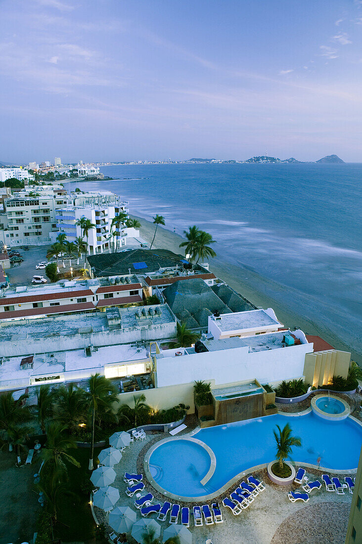 MEXICO-Sinaloa State-Mazatlan: Zona Dorado/ Golden Hotel Zone-Playa Las Gaviotas Beach view above Las Flores Hotel Pool / Evening