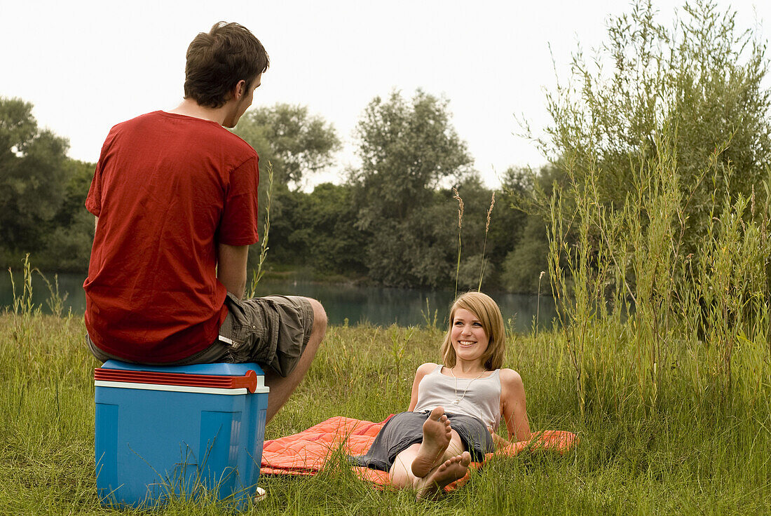 Teenage couple at quarry pond, Freising, Bavaria, Germany