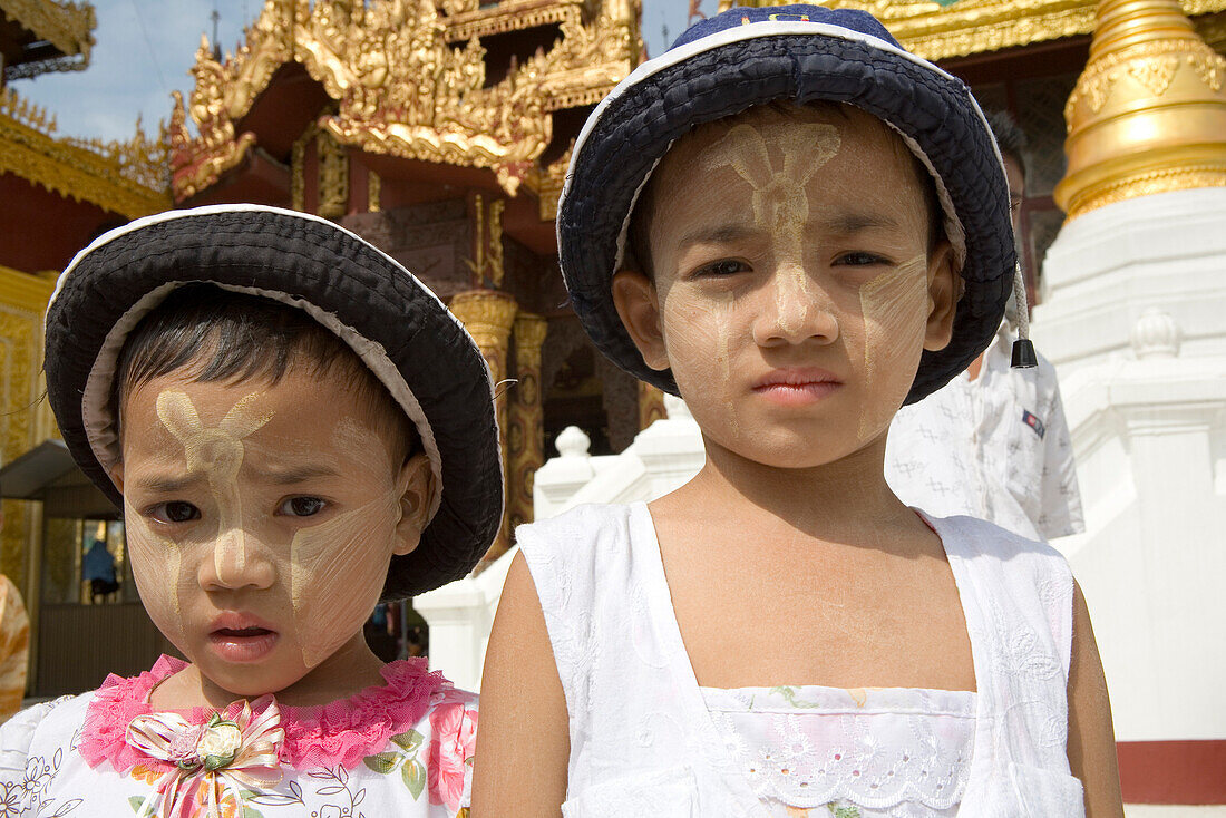 Two burmese girls in front of the Shwedagon Pagoda at Yangon, Rangoon, Myanmar, Burma