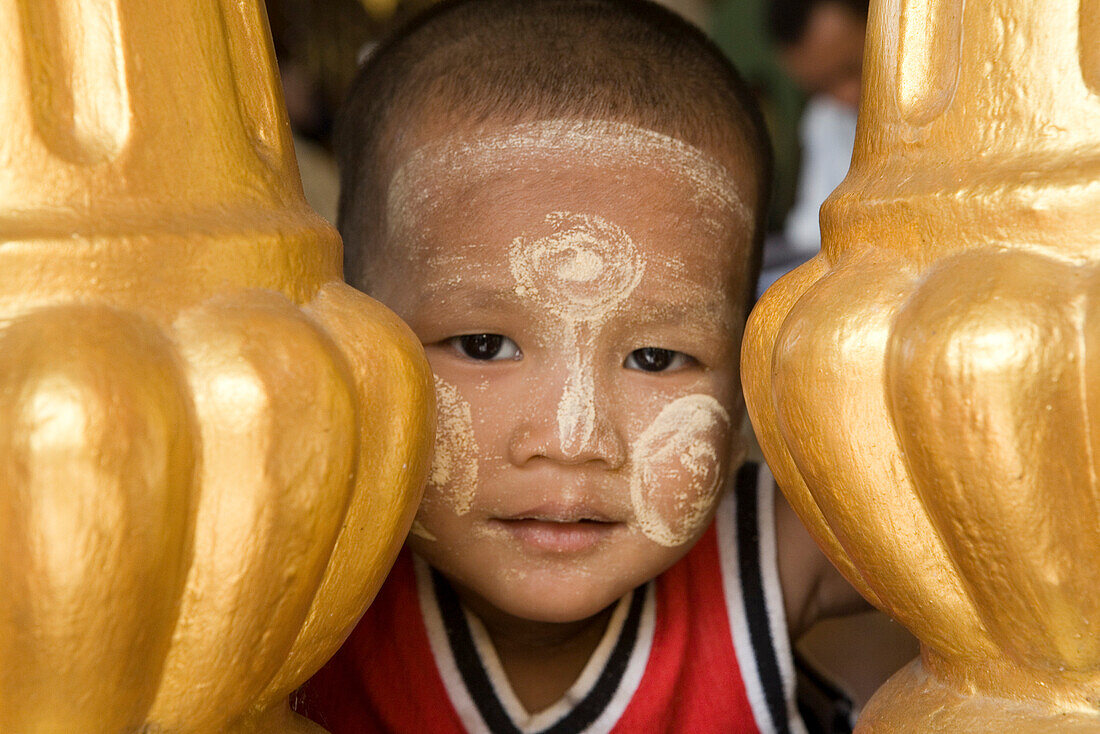 Face of a young burmese boy on the grounds of the Shwedagon Pagoda at Yangon, Rangoon, Myanmar, Burma