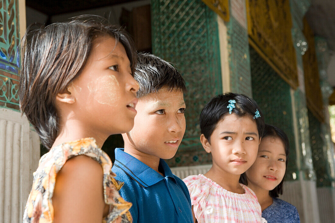 Four burmese children on the grounds of the Shwedagon Pagoda at Yangon, Rangoon, Myanmar, Burma