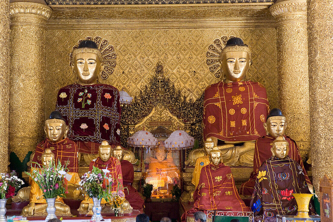 Buddha statues in golden prayer hall on the grounds of the Shwedagon Pagoda at Yangon, Rangoon, Myanmar, Burma