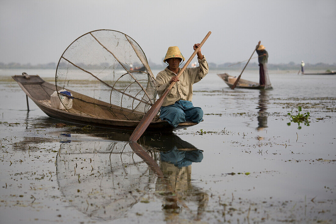 Intha fishermen on their fishing boats on Inle Lake, Shan State, Myanmar, Burma