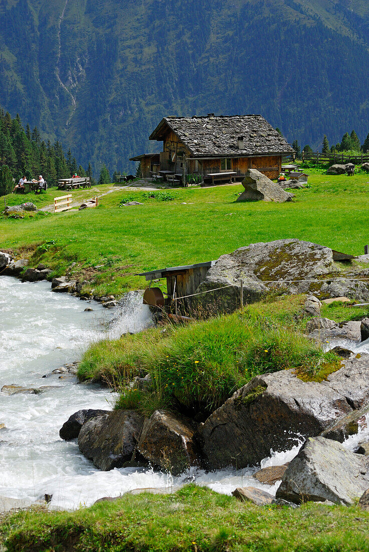 alpine hut Ochsenalm with stream, hut Falbesoner Alm, Stubaier Alpen range, Stubai, Tyrol, Austria