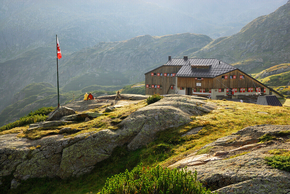 couple in front of hut Sulzenauhuette, Stubaier Alpen range, Stubai, Tyrol, Austria