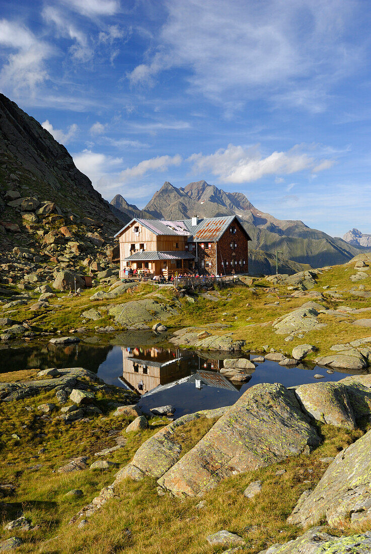 hut Bremer Huette and reflections in little lake, Habicht in background, Stubaier Alpen range, Stubai, Tyrol, Austria