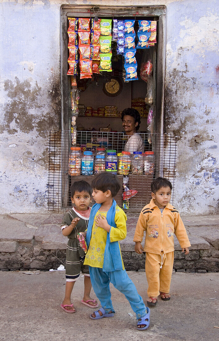 Children in front of shop, Allahabad. Uttar Pradesh, India