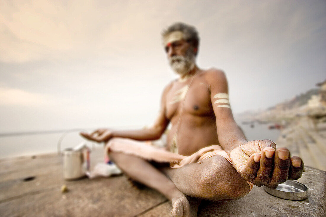 Man meditating by the Ganges, Varanasi. Uttar Pradesh, India