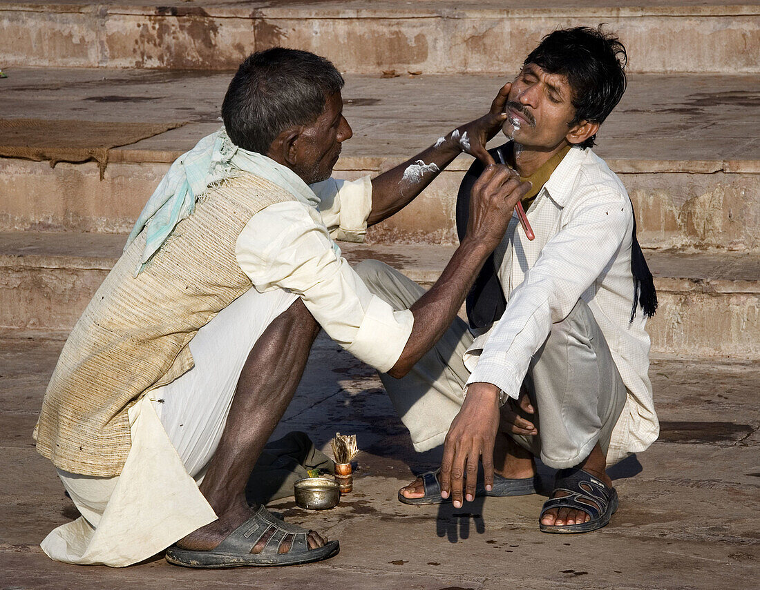 Barber at work, Varanasi. Uttar Pradesh, India