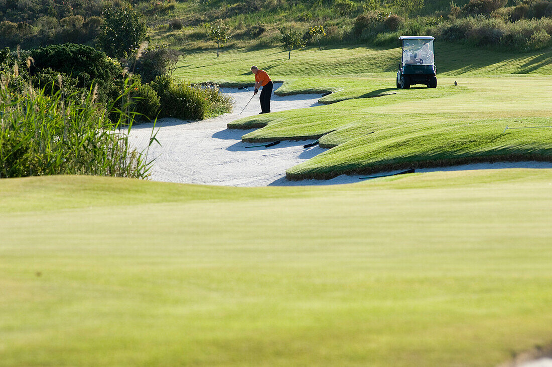 A man playing golf on the golf course of the Arabella Western Cape Hotel & Spa, Hermanus, Western Cape, South Africa, Africa