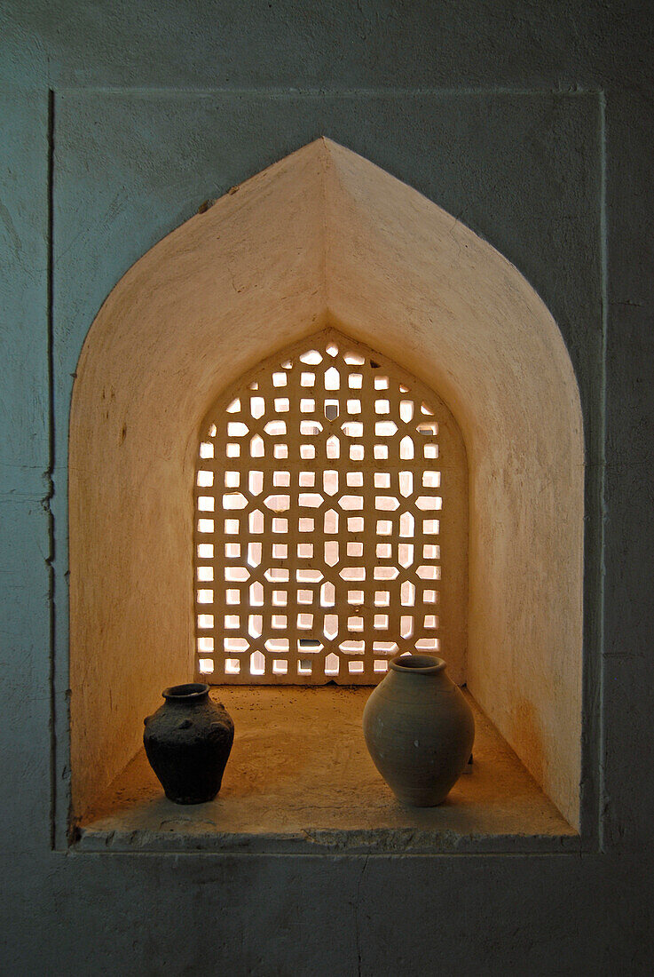 Stoneware jugs in front of a window, Fort Jabrin, Oman, Asia