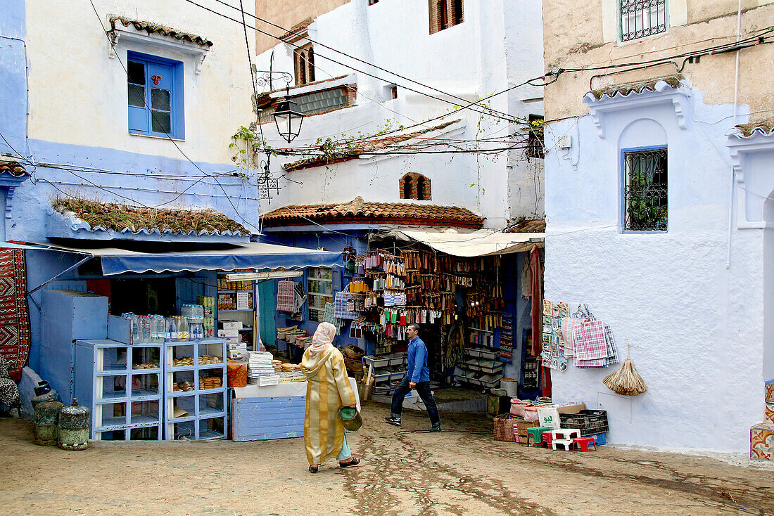 People walking through the alleys of Chefchaouen's medina, Chefchaouen, Morocco, Africa