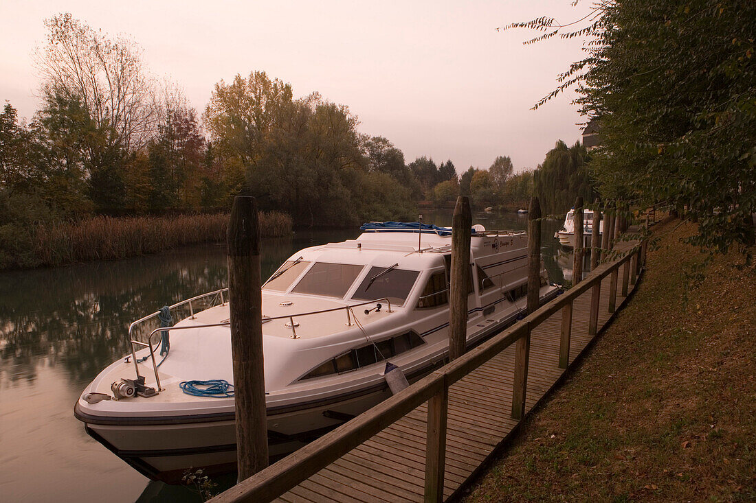 Le Boat houseboats moored on the banks of the canal at sunrise, Casale sul Sile, Veneto, Italy