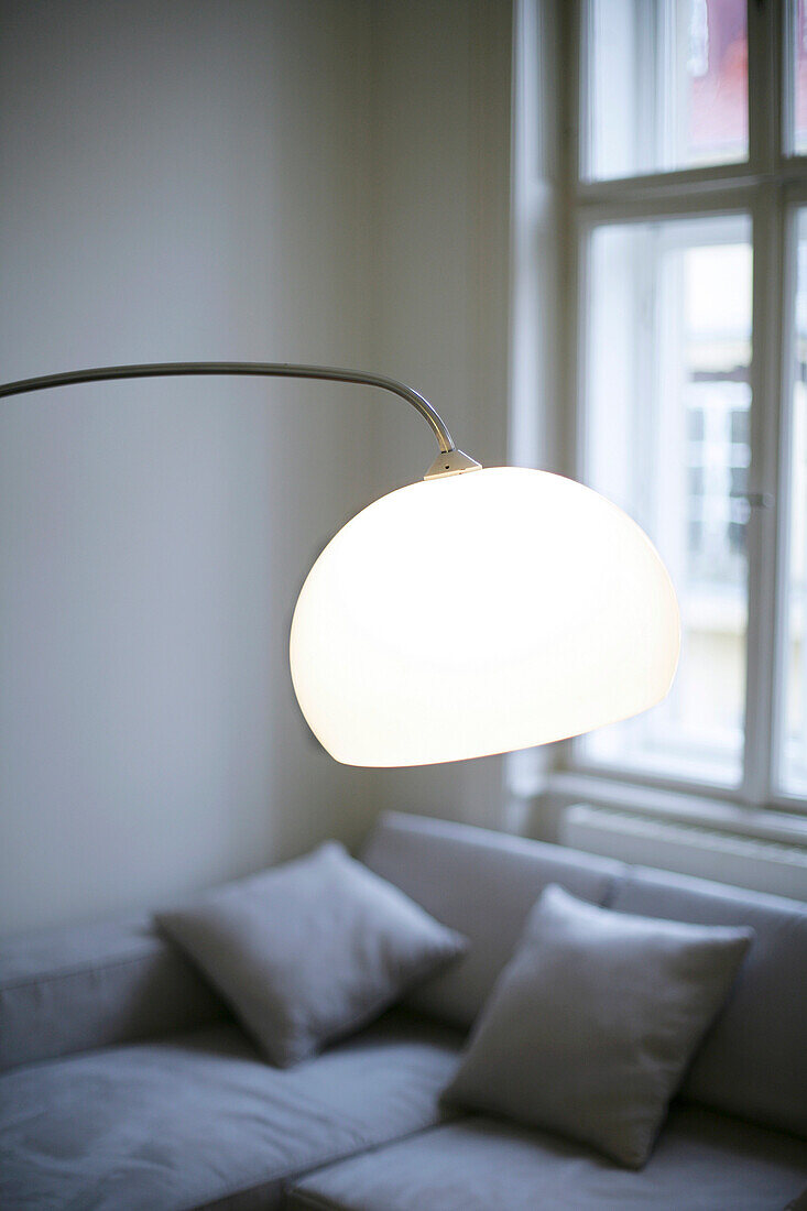 modern illuminated lamp, sofa with pillows, without colours