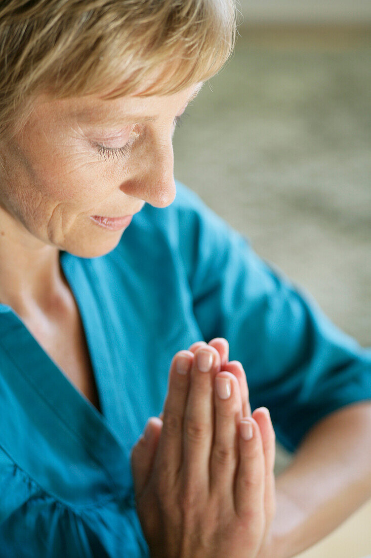 Mature woman meditating, Styria, Austria