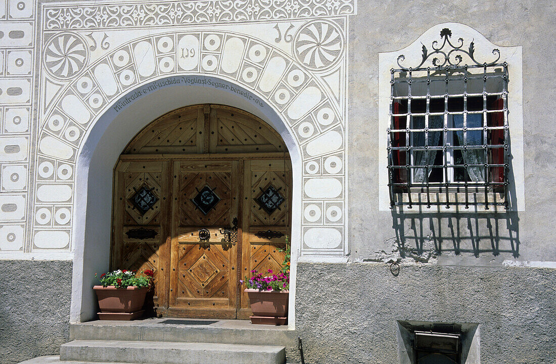 Detail at typical house Engadiner Haus with paintings sgraffiti around door and window, Scuol, Schuls, Unterengadin, Engadin, Grisons, Switzerland