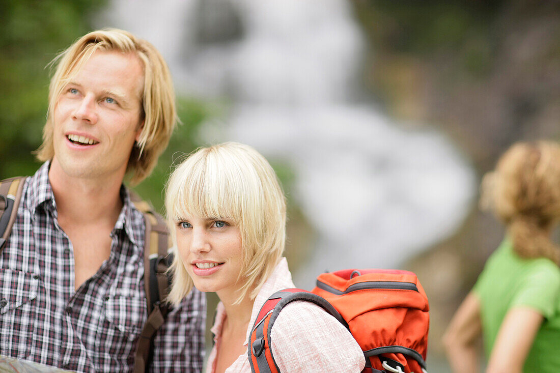 Hikers near waterfall, Werdenfelser Land, Bavaria, Germany