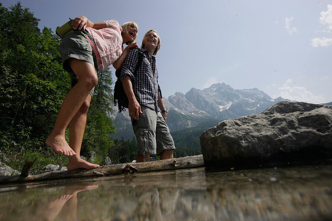 Young couple in lake Eibsee, Werdenfelser Land, Bavaria, Germany